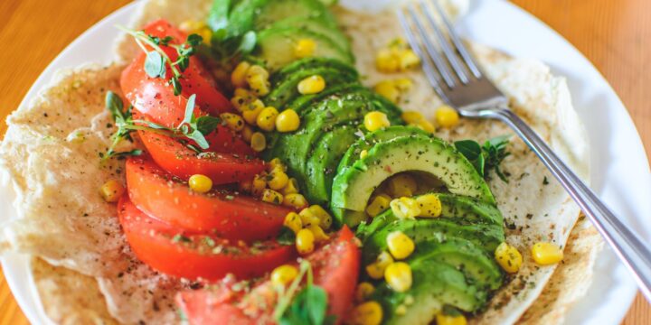 Sliced Tomato and Avocado on White Plate