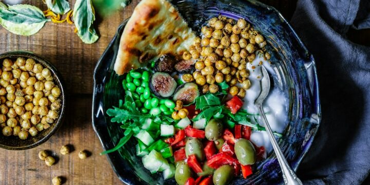 silver spoon on black ceramic bowl with vegetables