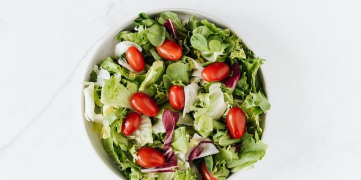 Bowl of fresh vegetable salad on table