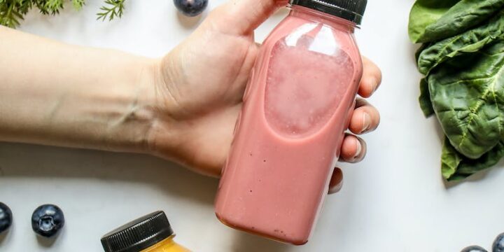 Person Holding Bottle with Smoothie