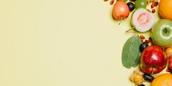 Ripe fresh fruits on beige surface