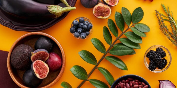 Leaves Among Fruits and Vegetables on Orange Background