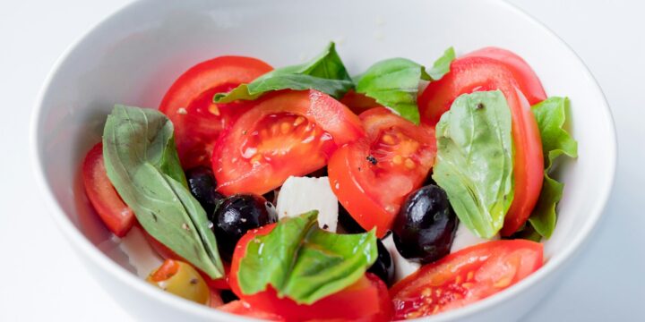 red and green bell pepper on white ceramic bowl