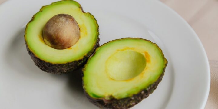 sliced avocado fruit on white ceramic plate