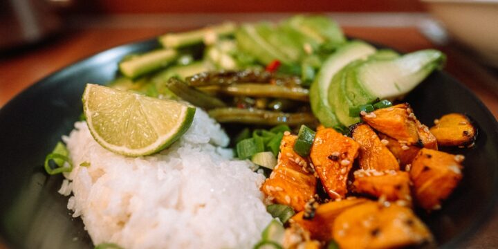 sliced carrots and green vegetable on white ceramic plate