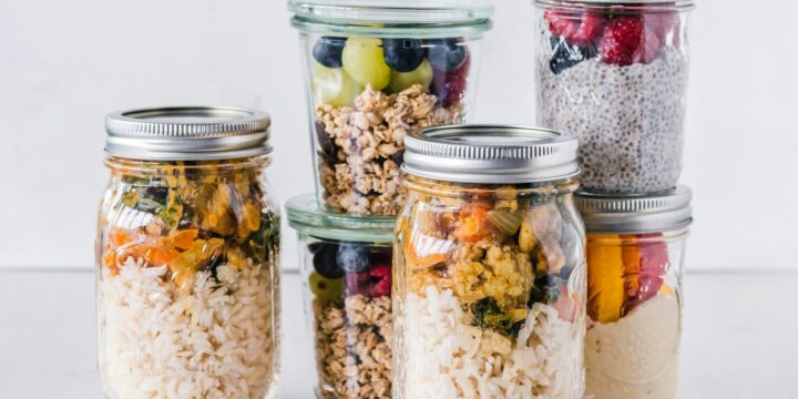 six full clear glass jars on white surface