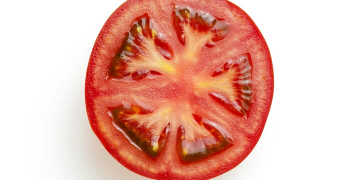 sliced tomato on white surface