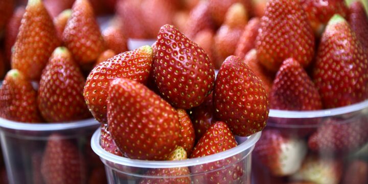 red strawberries in clear plastic container