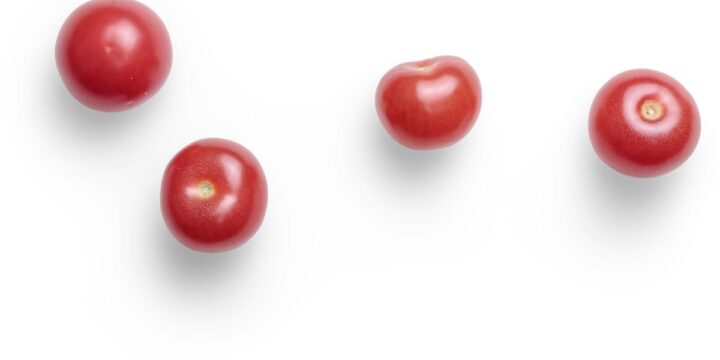 red round fruits on white background